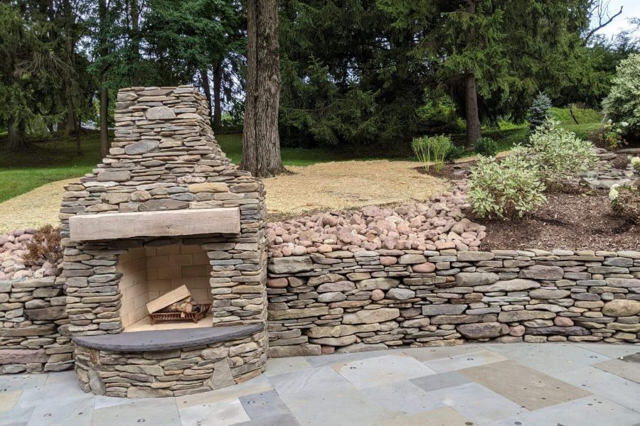 Retaining wall and outdoor fireplace made out of natural stone